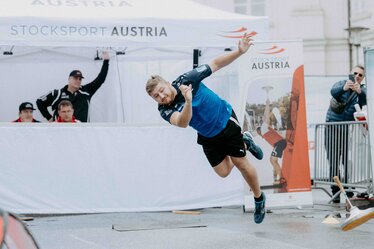 A white, printed folding gazebo from Ecotent's E2 series measuring 4.5 x 3 metres with side walls is used at a sports event organised by Stocksport Austria.
